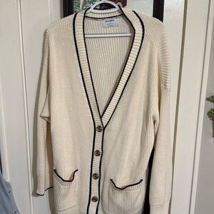 Cream cardigan with navy trim.